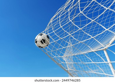  Soccer ball in soccer goal net in a big stadium isolated on blue sky. soccer net. - Powered by Shutterstock