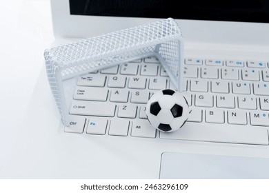 Soccer ball and goal on laptop keyboard - Powered by Shutterstock