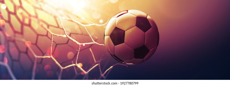 Soccer Ball In The Net In The Sunbeams. Golden Background