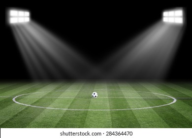 Soccer ball on field in stadium at night - Shutterstock ID 284364470
