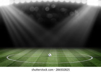 Soccer ball on field in stadium at night - Shutterstock ID 286502825