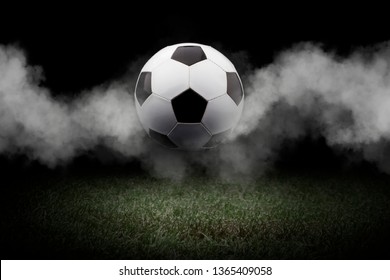 soccer ball on soccer field.soccer ball (football) on green grass with dark toned foggy background.