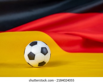 Soccer ball on the German flag. The ball against the background of the German flag. The concept of the German football game.