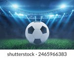 Soccer ball on the grass in a modern stadium with blue bright floodlights. Soccer World Cup. Euro 2024, creative idea. Champions game at night. Winner