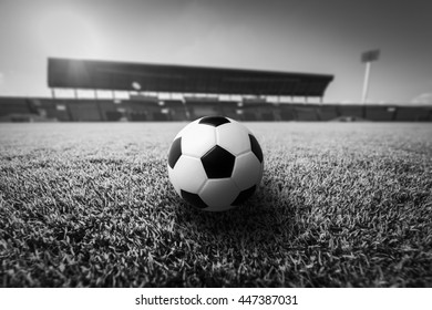 Soccer Ball On Grass In Soccer Stadium. Black And White.