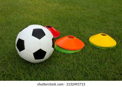 soccer ball on green grass with marker training cone, children training academy and youth football center, soccer school concept - Powered by Shutterstock