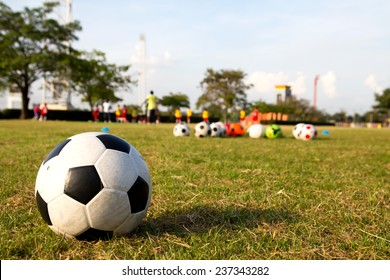 Soccer Ball On Green Grass And Children Training Academy, Youth Soccer Center.