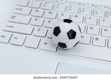 Soccer ball on laptop keyboard - Powered by Shutterstock