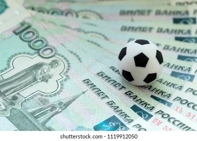 A soccer ball on Russian banknotes with a face value of one thousand rubles. Close-up. The concept of corruption, bribes or sports betting. - Powered by Shutterstock