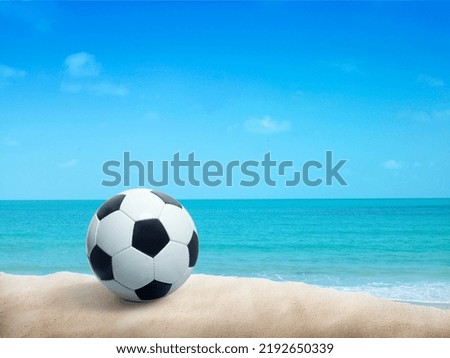 Soccer ball on sandy beach after game