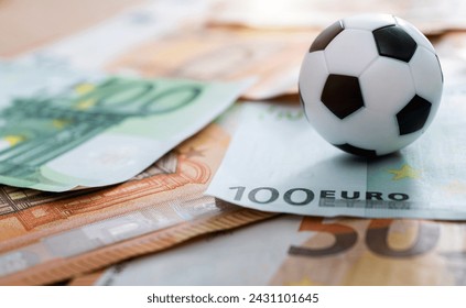 Soccer ball on stack of euro - Powered by Shutterstock