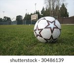 A soccer ball on Stanton Field on the campus of Santa Clara University, Buck Shaw Stadium in the background