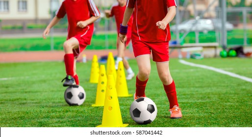 Soccer Ball and Pylons on Grass. Youth Soccer Player Training. Young Footballer with Ball Training with Cones