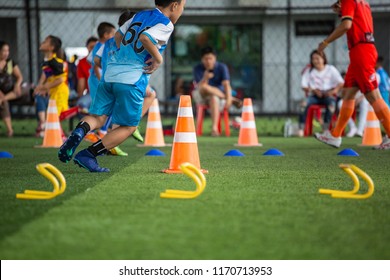 Soccer ball tactics on grass field with cone for  training children jump skill in Soccer academy - Powered by Shutterstock