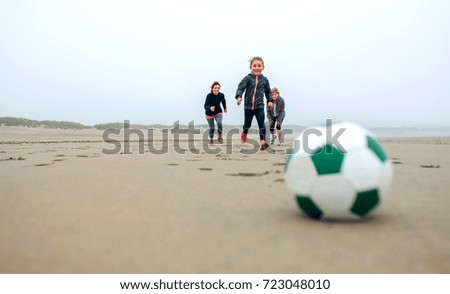 Similar – Girl and senior woman playing on the beach