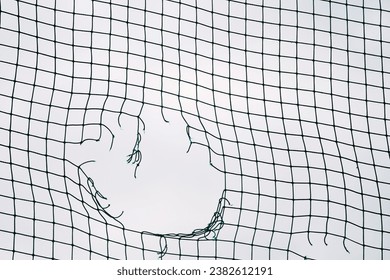 Soccer Ball Triumph. Breaking the Goal Net. Concept of football goal. Close Up of a Soccer Goal Net. Close-Up of Victory concept. - Powered by Shutterstock