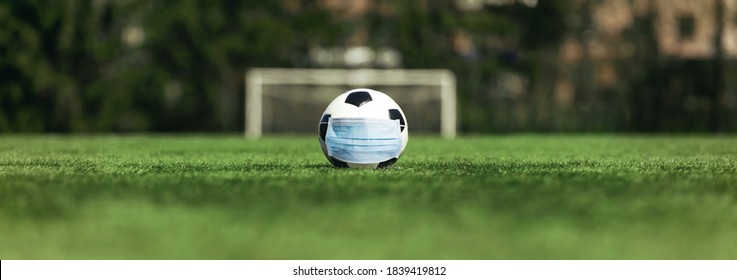 soccer cancellation event concept. Ball with coronavirus mask