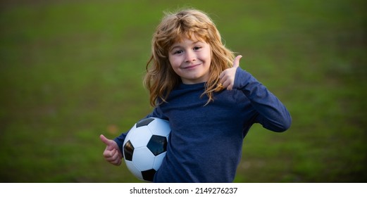 Soccer child play football. Kid holding soccer ball, closeup kids portrait show thumbs up success sign.