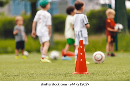 Soccer Class for Kids. Physical Outdoor Activities for Kids. Children Running at Practice Field. Elementary-Age Children at Slalom Training Drill - Powered by Shutterstock