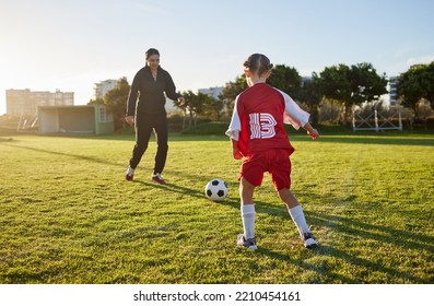 Soccer, coach and child sport on a outdoor school field with a ball for fitness and exercise. Trainer training a kid student for football training, workout and children sports game kick together - Powered by Shutterstock