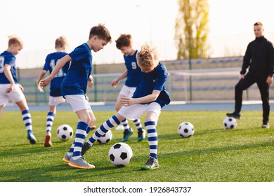 Soccer Education for Young Boys. Physical Education Class for School Children. Young Coach With Kids in Team on Training Unit. Youth Team Coach Training School Boys in Football Soccer