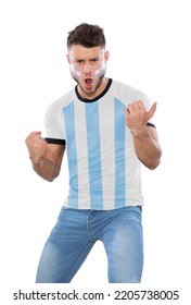 Soccer fan man with white and light blue jersey and face painted with the flag of the Argentina team screaming with emotion on white background.