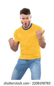 Soccer Fan Man With YELLOW Jersey And Face Painted With The Flag Of The ECUADOR Team Screaming With Emotion On White Background.