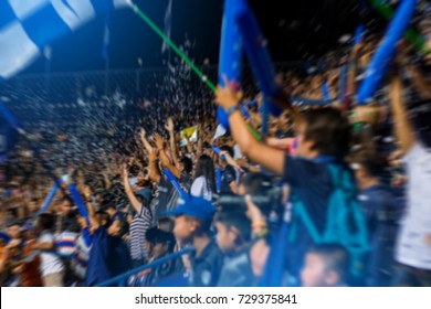 Soccer Fans In Stadium Celebrate There Goal In Soccer Match. Blurred Image