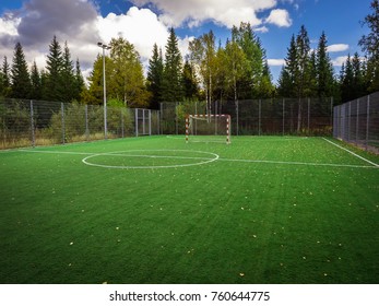 Soccer Field With Green Grass Yard And Football Goal In School Area. Beautiful Sport Playground.