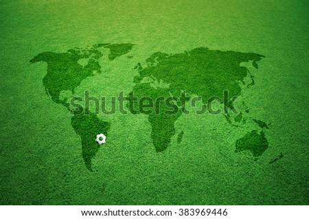 Soccer field with world map caption and small soccer ball.