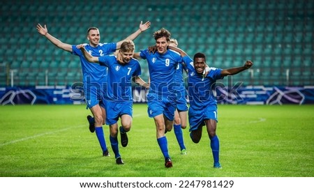 Soccer Football Championship: Blue Team Forward Attacks and Scores Goal, Win the Match, Players Happy, Celebrate Victory, Win Tournament. Sport Channel Broadcast Television Concept. Foto stock © 