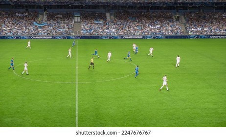 Soccer Football Championship Stadium with Crowd of Fans: Blue Team Attacks, Forward Dribbles, White Team Defending The Goals, Ready To Counterattack. Sports Channel Broadcast Television. High Angle. - Shutterstock ID 2247676767