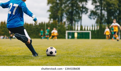 Soccer Football Goalkeeper Goal Kick. Goalie Kick On The Pitch During Match. Goalkeeper Restarting Play In A Game 