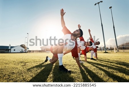 Soccer, football player and team stretching for sports match, training and practice of athlete men before game on outdoor field. Exercise, fitness and workout with male group ready for sport on grass