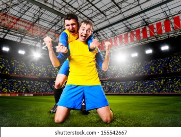 Soccer Or Football Players Are Celebrating Goal On Stadium