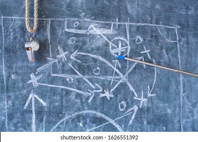 soccer or football tactics scribble with the whistle and pointer stick of the coach on black board
