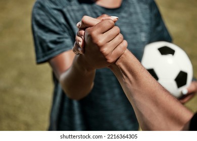 Soccer, football and team handshake on field before start of match, game or competition. Teamwork, collaboration and soccer players shaking hands before exercise, workout or training on grass field. - Powered by Shutterstock