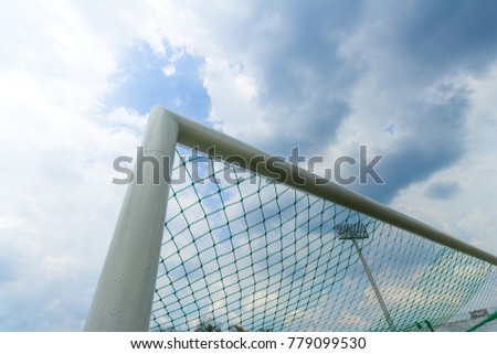 Soccer goal against a cloudy sky background.