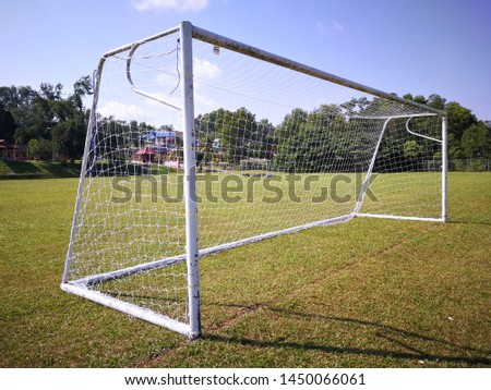 Soccer goal on the football field with blue sky.