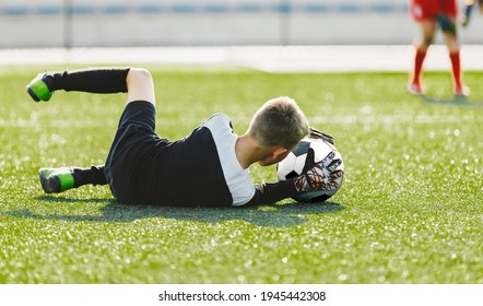 Soccer Goalie Drills. Young Boy as a Soccer Goalkeeper in Action Catching Ball. Football Kid Saving Ball Practice Session. Young Football Goalie Practice Training Saving Drill