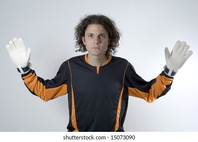 Soccer Goalie Wearing Gloves Looks Serious As He Has His Hands Out. Horizontally Framed Photograph.