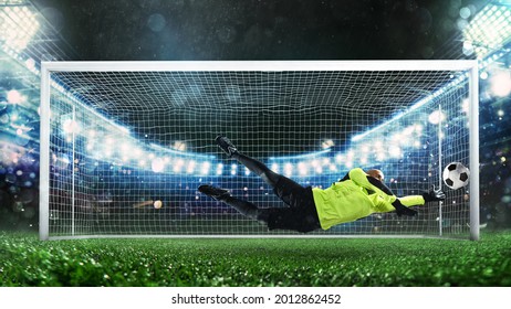 Soccer goalkeeper, in fluorescent uniform, that makes a great save and avoids a goal during a match at the stadium