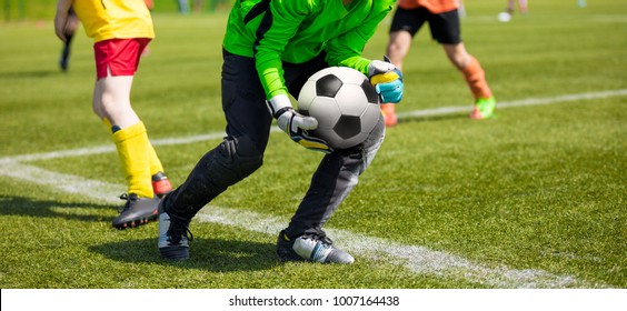 Soccer Goalkeeper Holding Soccer Ball. Soccer Goalkeeper Catching Skills. Youth Football Teams Compeeting in School Soccer Tournament - Powered by Shutterstock