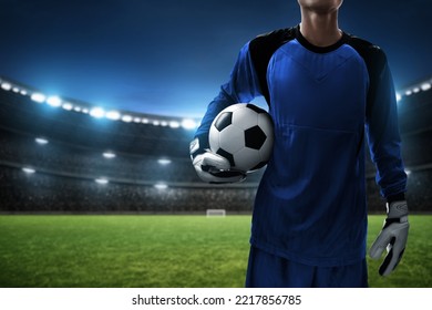 Soccer goalkeeper holding ball in the stadium - Powered by Shutterstock