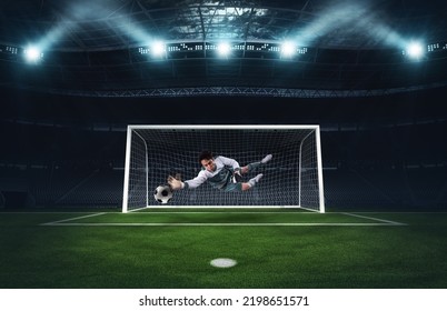 Soccer goalkeeper that makes a great save and avoids a goal during a match at the stadium