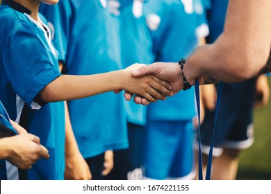 Soccer handshake during ceremony. Kids getting awarded with golden medals after school tournament. Child and adult handshaking - Powered by Shutterstock