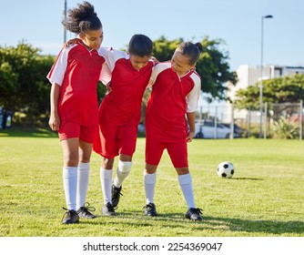 Soccer, injury and children team help, support and walk with hurt friend during game at a sports field. Sport, accident and kids football group helping girl player after fitness, training and match - Powered by Shutterstock