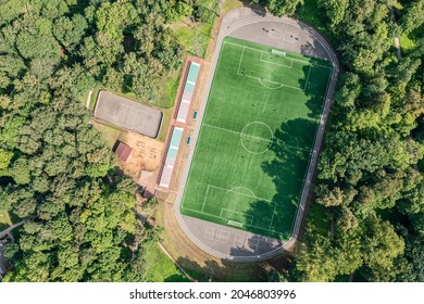 Soccer Pitch With Amateur Football Players Playing The Game In The City Park At Sunny Summer Day. Aerial Overhead View.