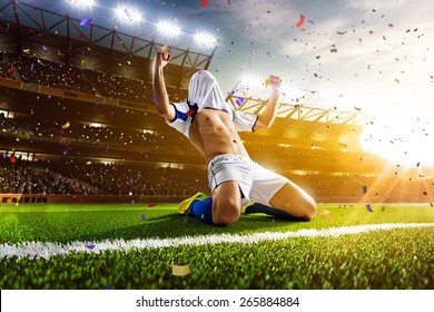 Soccer player in action on night stadium panorama background - Powered by Shutterstock