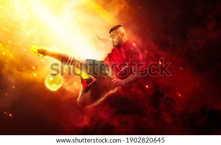 Soccer player in action on smoke background. Sports banner. Copy space background